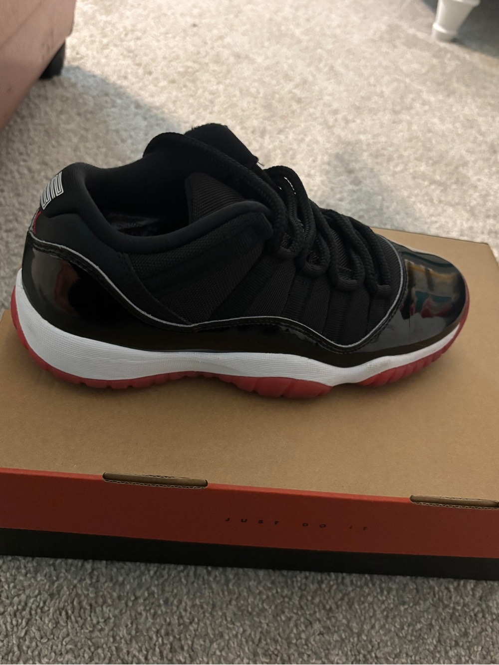 Jordan 11 low Black Patent Low-Top Sneaker with Red Sole